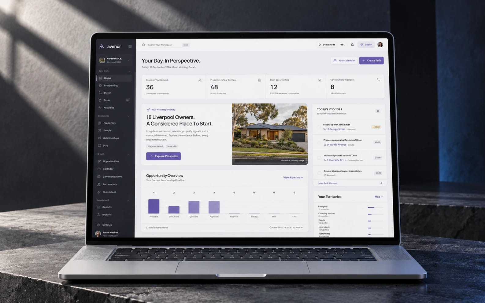 Avenor’s existing property software dashboard displayed on a laptop in a graphite stone studio setting.
