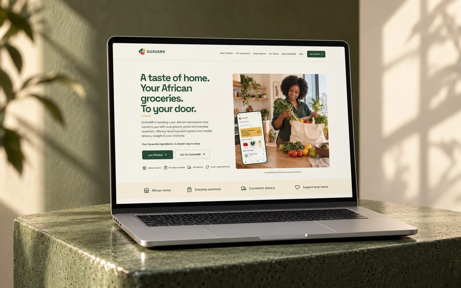 GUAVARR’s existing grocery marketplace website displayed on a laptop in a moss-green ceramic studio setting.
