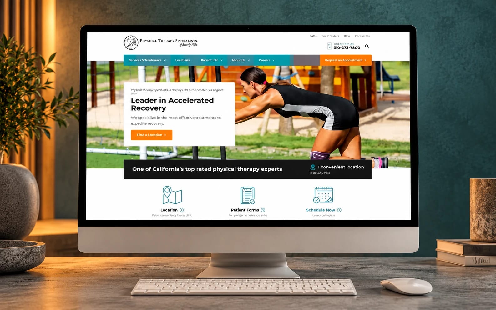 Physical Therapy Specialists’ existing website displayed on a monitor in a concrete and muted-teal studio.