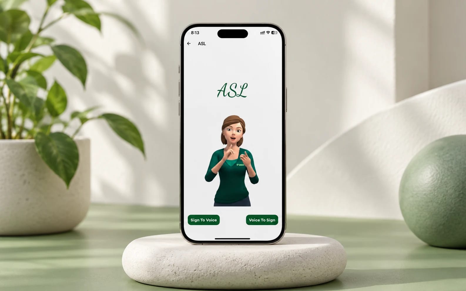 The existing Sign Language App displayed on a phone in a chalk-white and sage-green studio setting.