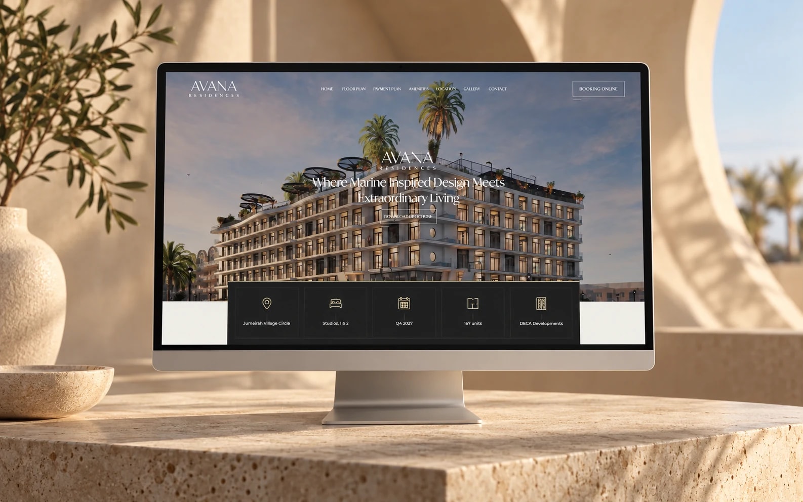 Avana Residences’ existing luxury property website on a monitor in a warm travertine architectural setting.