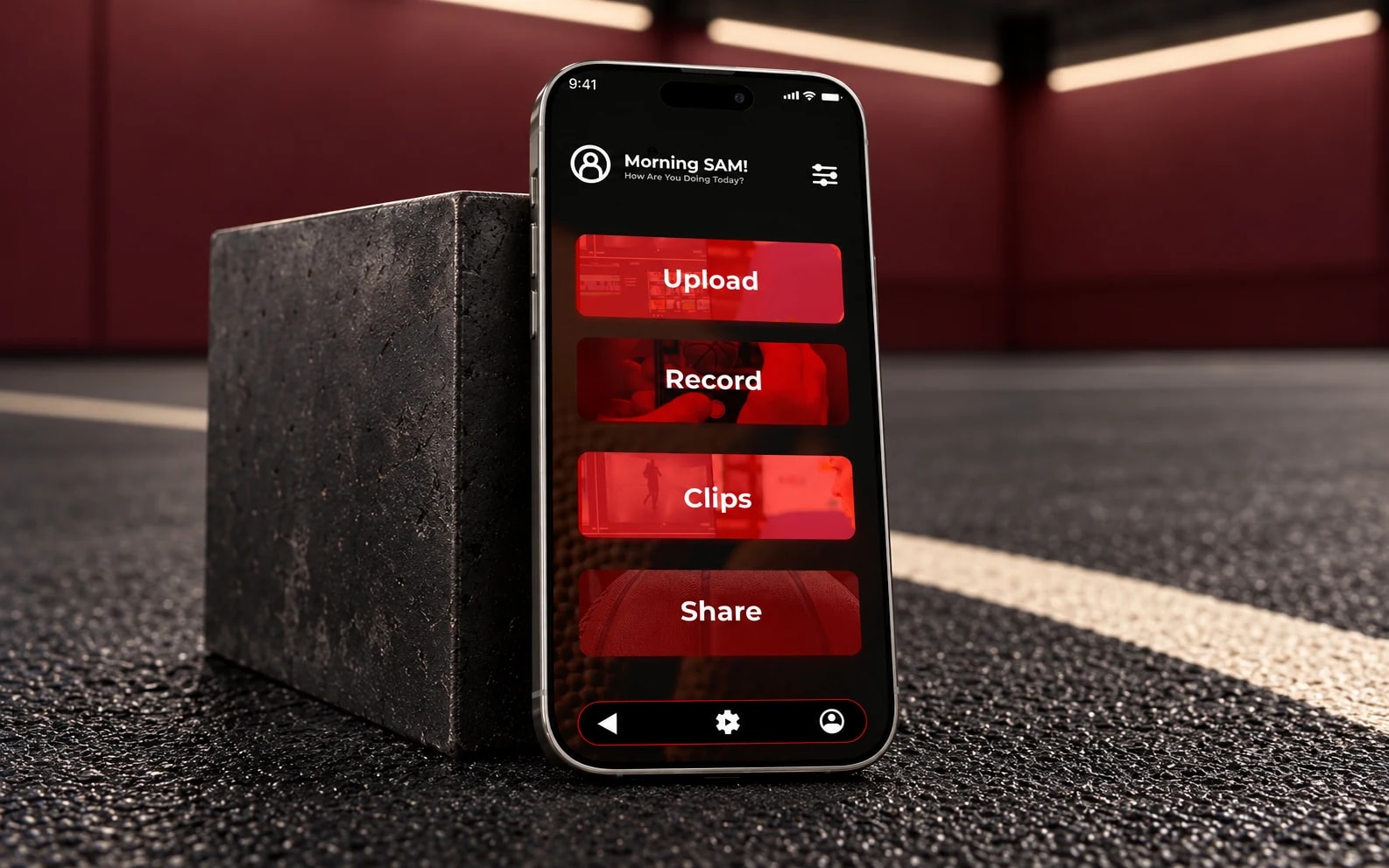Ballify’s existing basketball app displayed on a phone in a charcoal and burgundy sports-inspired studio.