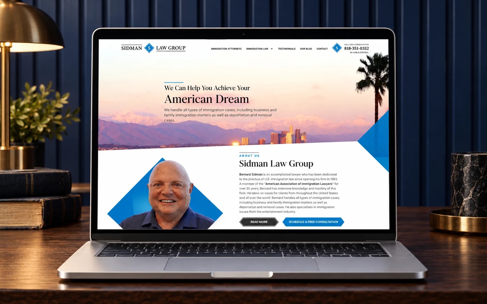 Sidman Law Group’s existing website displayed on a laptop in a walnut and navy architectural studio.