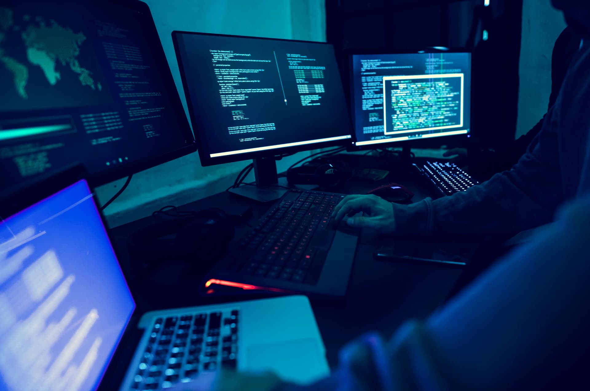 Developer workspace with code displayed across multiple monitors